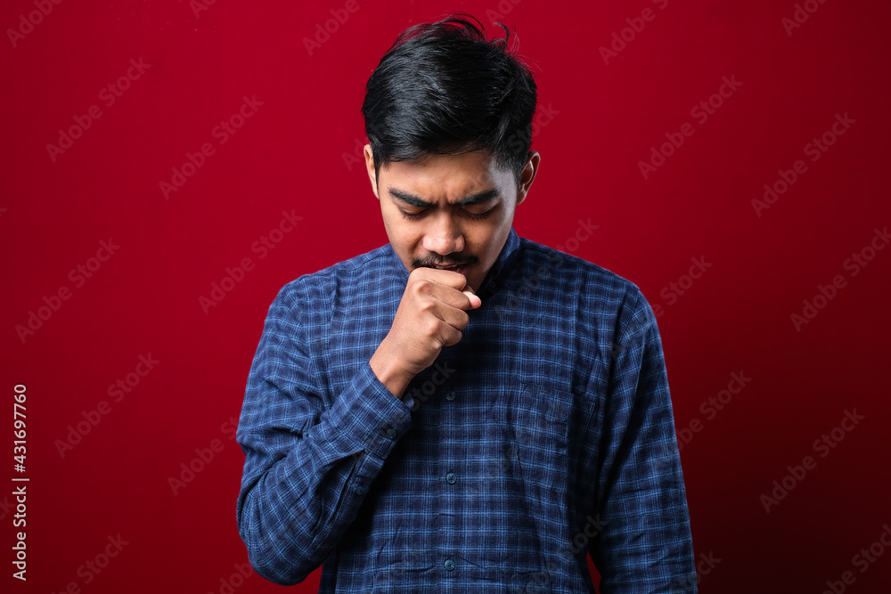 Young asian man coughing with sore throat, concept of man with allergy Young asian man coughing with sore throat, concept of man with allergy