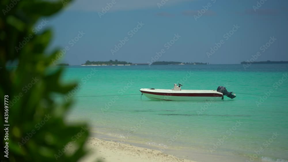 Island In Maldives - Boat Floating Over The Crystal Clear Sea Water. near the beach. Sunny day in paradise. Many island resorts on the horizontal. Island In Maldives - Boat Floating Over The Crystal Clear Sea Water. near the beach. Sunny day in paradise. Many island resorts on the horizontal.
