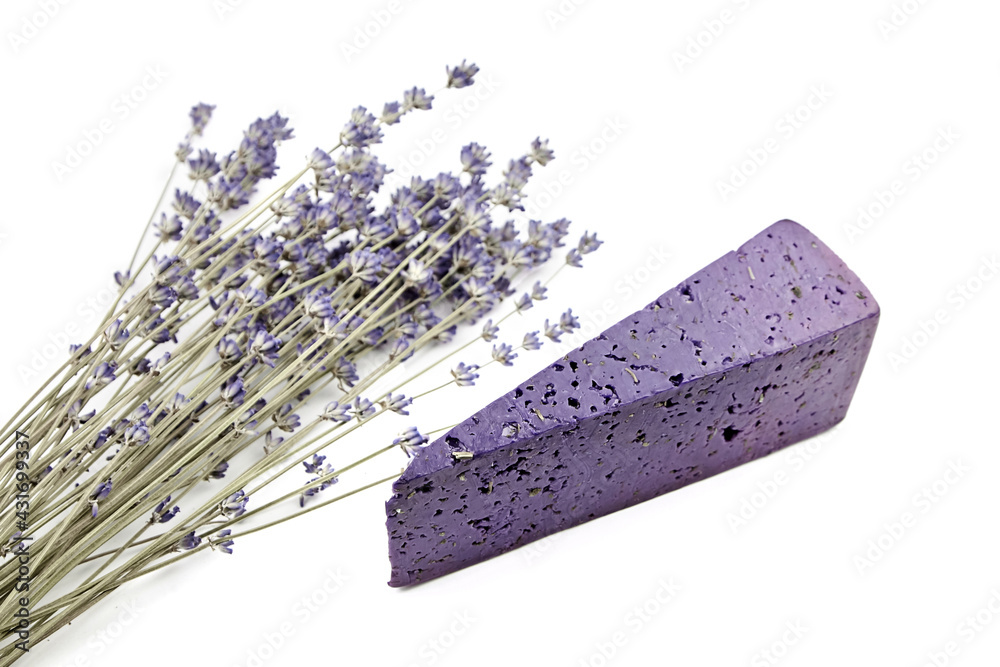 Lavender cheese with dry basil and lavender flowers isolated on white background.