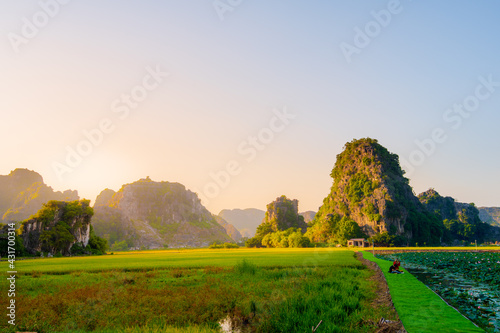 Beautiful sunset over Vietnamese Landscape from the scenic Mua Caves and Dragon Statue in Tam Coc, Ninh Binh, Vietnam