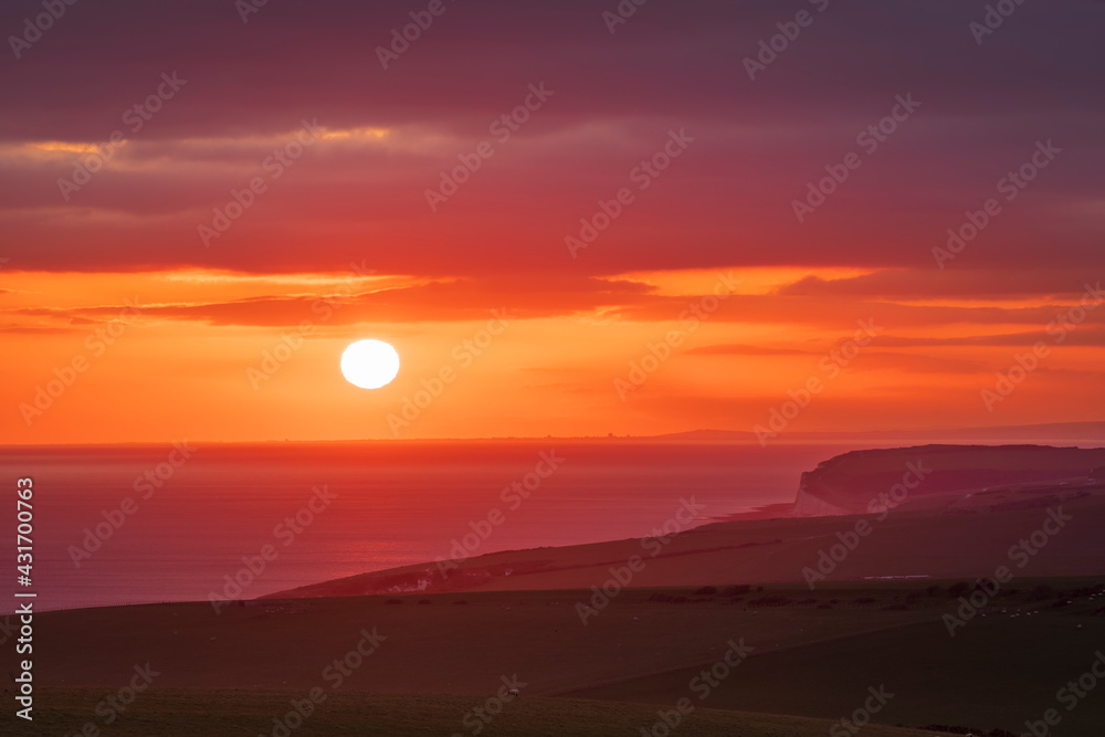 April sunset out to sea from Beachy Head on the South Downs East Sussex April sunset out to sea from Beachy Head on the South Downs East Sussex
