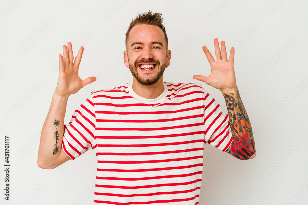 Naklejka premium Young tattooed caucasian man isolated on white background joyful laughing a lot. Happiness concept.