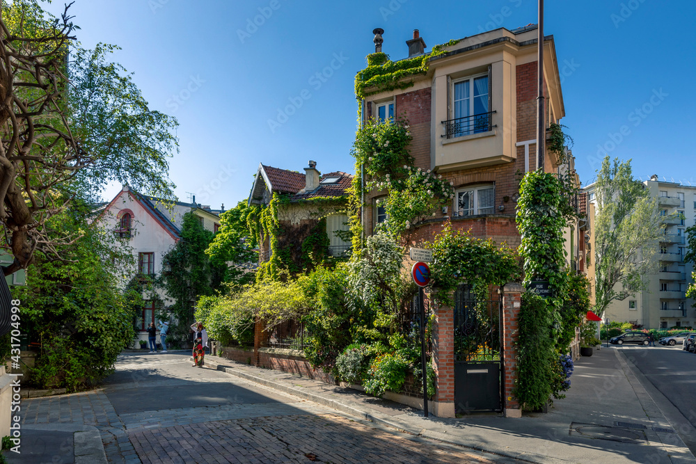 Paris, France - April 26, 2021: The floral city (Cité florale) is a residential area located in the 13th arrondissement of Paris, France. It forms a triangular area with individual houses - obrazy, fototapety, plakaty 