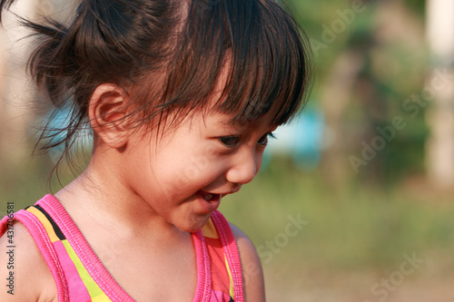 Portrait of asian baby girl, a cute face and smiling ,Walking in the front yard