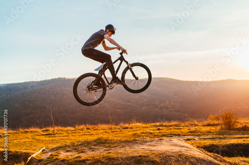 Young man flying through the air on a mountain bike © kerkezz