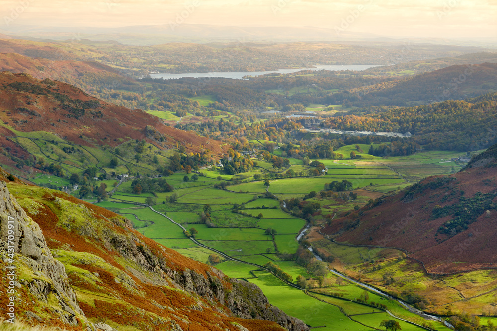 Scenic aerial of Great Langdale valley in the Lake District, famous for its glacial ribbon lakes and rugged mountains. Popular vacation destination in Cumbria, North West England.