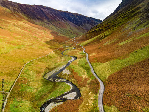 Photos Aerial view of Honister Pass, a mountain pass with a road winding along Gatesgarthdale Beck mountain stream
