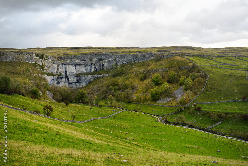 Malham Cove, a huge curving amphitheatre shaped cliff formation of limestone rock in Yorkshire Dales National Park in northern England