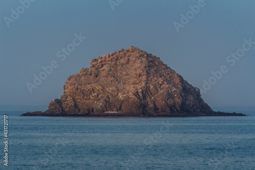 Lonely island in the sea at sunset