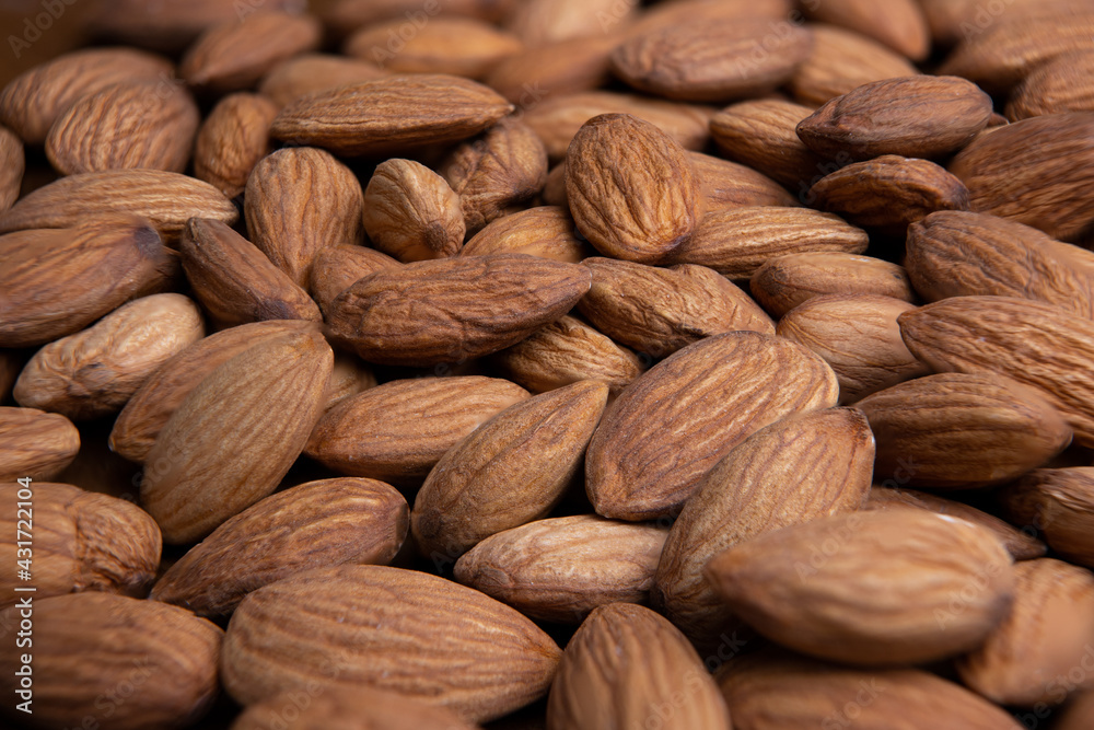 Fototapeta premium Almonds horizontal background closeup.