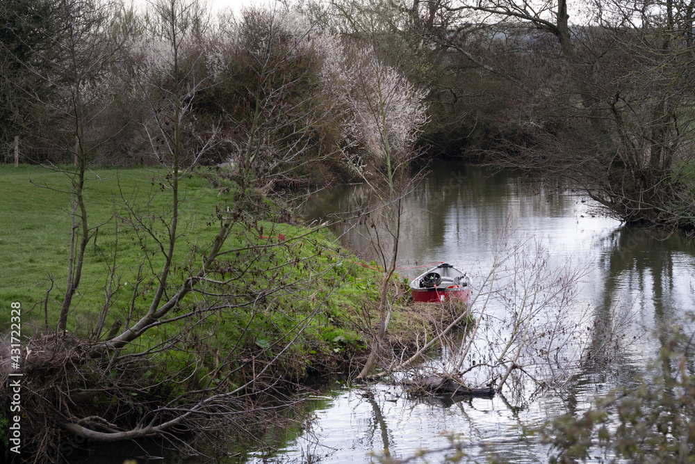 Naklejka premium Walking on the Ouse way, Barcombe Mills, England, a small boat moored on the bank