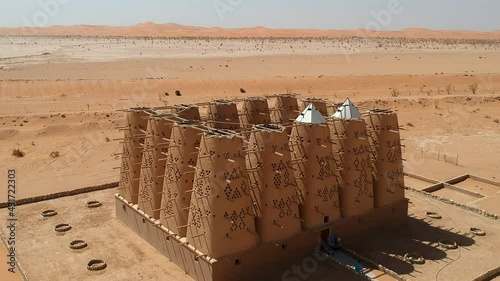 Camera drone flies over the abandoned traditional mud brick Arab dovecote in the Riyadh Province, Saudi Arabia photo