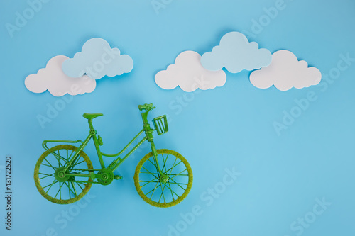 3rd June World Bicycle Day. Green bicycle on blue background. Environment preserve. © vetre