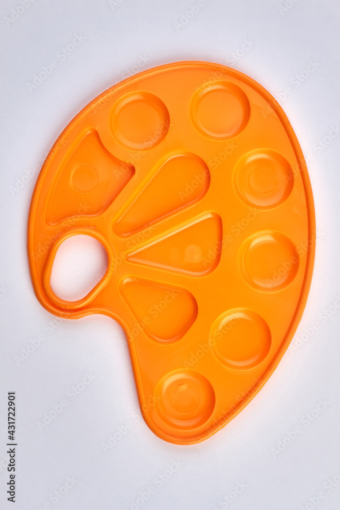 Top view of new empty yellow plastic palette for paints. Top view of new empty yellow plastic palette for paints.