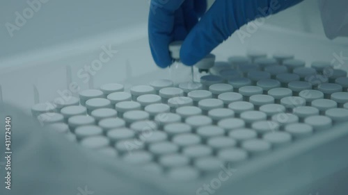 The doctor choosing a bottle of vaccine from a box