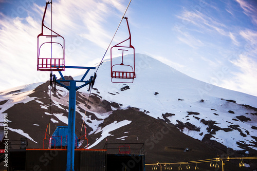 Villarrica volcano, Chile in the summer. It is possible to see the cable car that takes tourists to the base of the mountain. Snow, altitude, trekking, extreme sports. Landscape tourism. South America photo