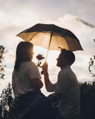 silhouette of a couple with a rose