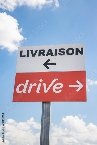 French "Delivery" and "Drive-through" road signs with arrows