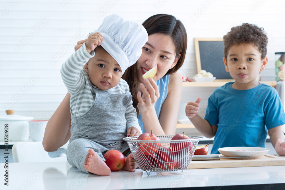 Happy mother and little child boy have good time together in kitchen, learning about food, Mother's day Happy mother and little child boy have good time together in kitchen, learning about food, Mother's day