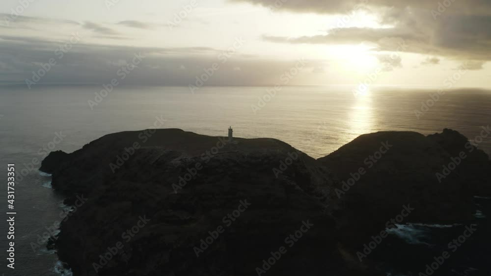 Silhouette of Lighthouse on Ilhéu de Ferro with bright sunlight at dusk Silhouette of Lighthouse on Ilhéu de Ferro with bright sunlight at dusk
