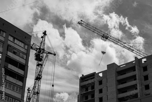 Construction of new building, man on the top of the building, сonstruction crane
