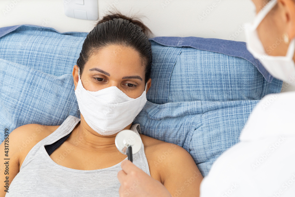 Patient in bed, looking at doctor's stethoscope. Patient in bed, looking at doctor's stethoscope.