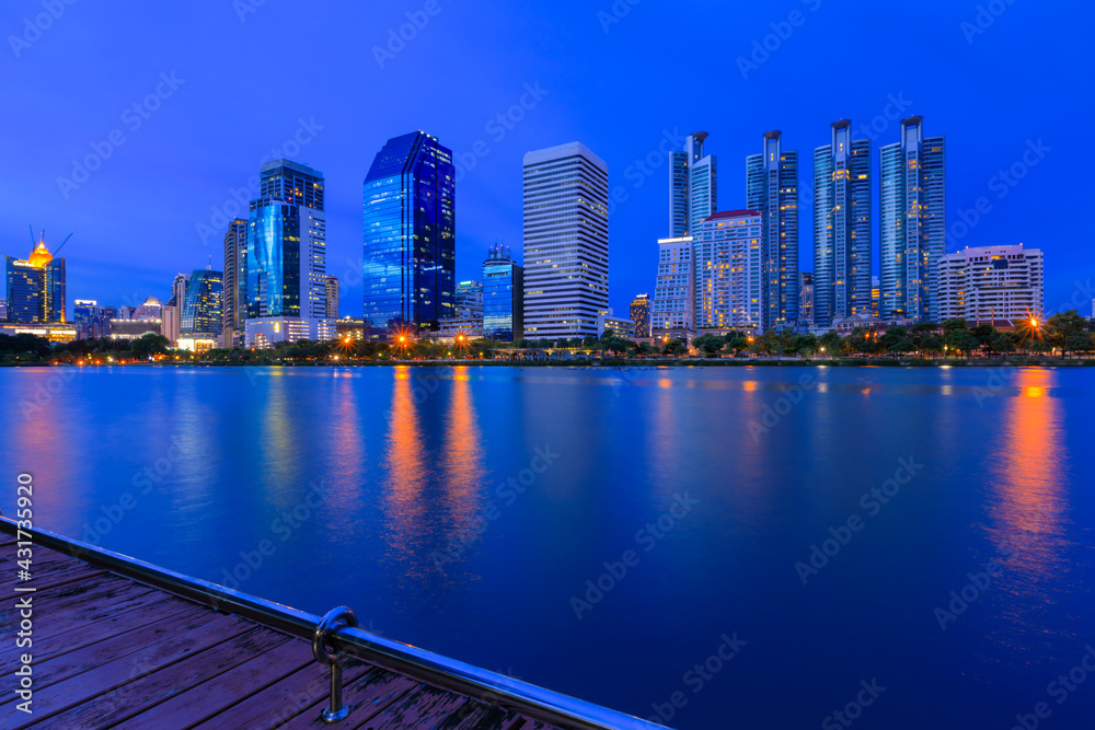 Obraz premium modern buildings of Bangkok night city skyline, Thailand. Cityscape photography of Benchakitti Park at dusk. Bangkok night city downtown. Modern night city skyline with lights reflection, Asia