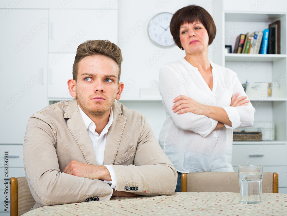 Fototapeta premium Elderly woman tries to persuade young man don't worry