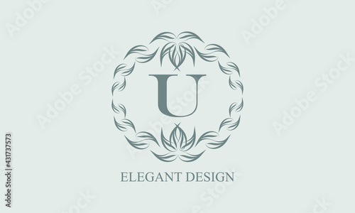 Elegant floral monogram with exquisite elements. Template for invitations, labels, business signs. Vintage ornament with calligraphic letter U. © Ігор Шунькін