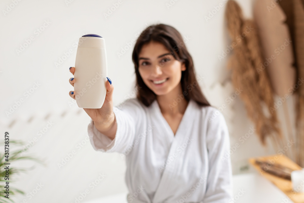 Lady Showing Shower Gel Bottle Advertising Cosmetics Product In Bathroom Lady Showing Shower Gel Bottle Advertising Cosmetics Product In Bathroom