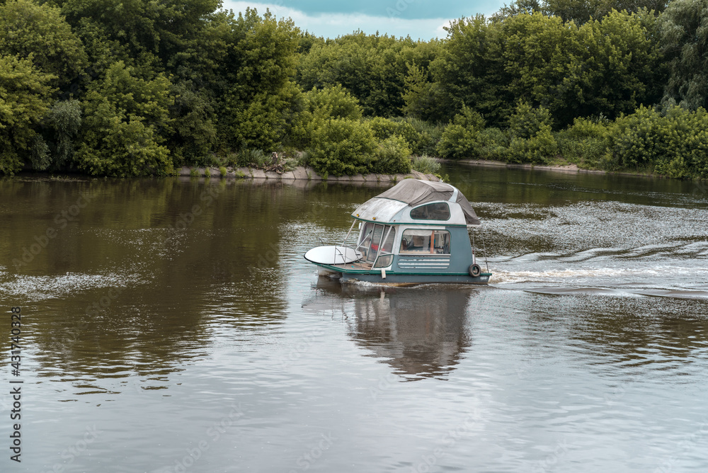 light-engine boat float floating on the river . light-engine boat float floating on the river .