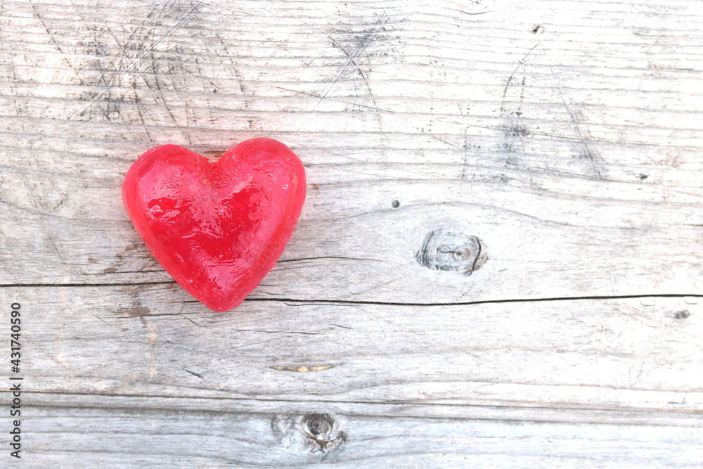 Red heart on natural wooden background as loving heart symbol for wedding greeting card with heart symbol or Valentine's Day card with beautiful red heart Red heart on natural wooden background as loving heart symbol for wedding greeting card with heart symbol or Valentine's Day card with beautiful red heart