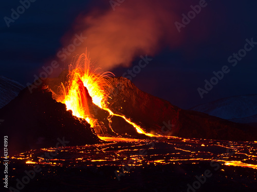 Stunning view of volcanic eruption in Geldingadalir valley near Fagradalsfjall mountain, Grindavík, Reykjanes peninsula, southwest Iceland with long exposure of lava ejection at night.
