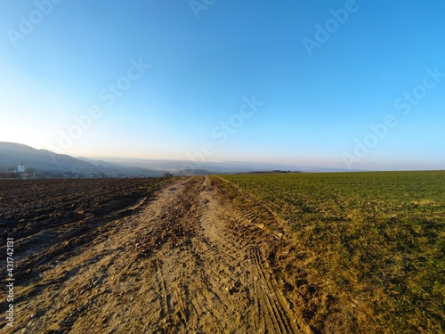 View over field into distance and blue sky