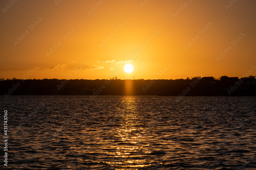 Beautiful sunset over water. Sunset in Bacalar, Mexico.