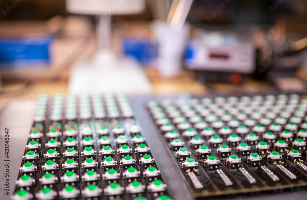 Close-up of a LED panel of green light indicators is in the production of automatic control systems. The concept of industrial production of equipment for military and strategic purposes Close-up of a LED panel of green light indicators is in the production of automatic control systems. The concept of industrial production of equipment for military and strategic purposes