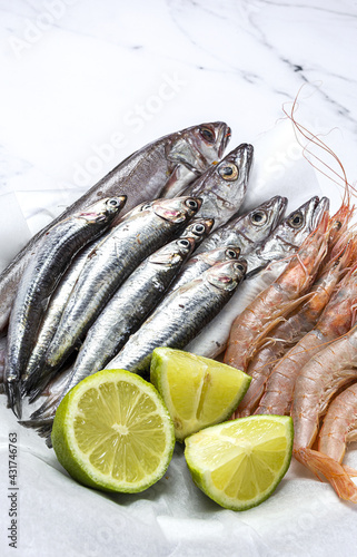 Anchovies, prawns and raw whiting prepared for frying. photo