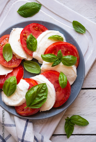 Caprese salad with mozzarella cheese, tomatoes and basil. Typical Italian cuisine