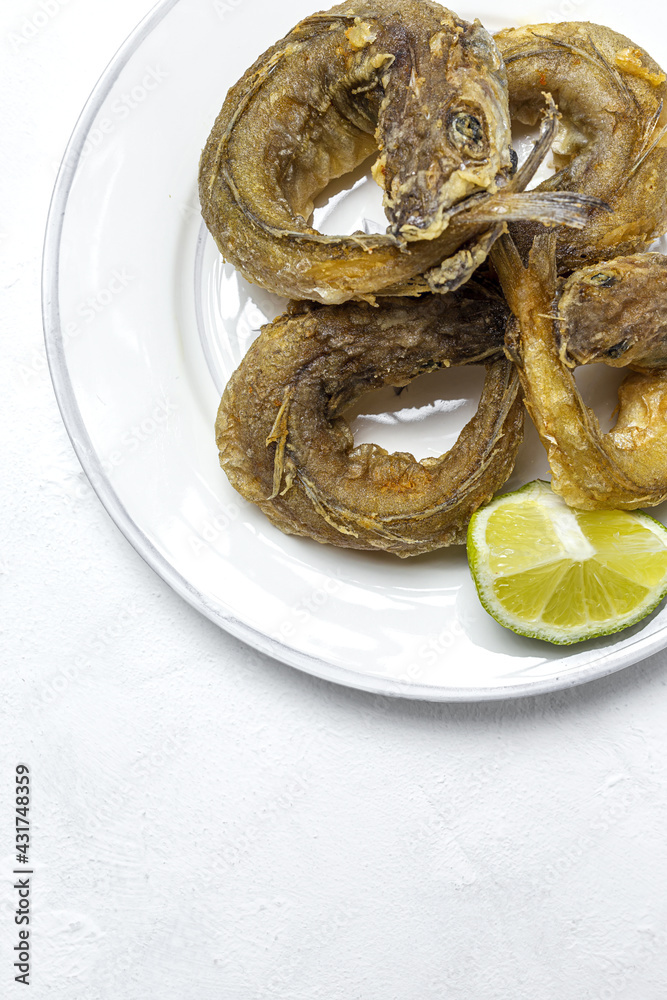 Typical Spanish frying of fried fish with lemon Typical Spanish frying of fried fish with lemon