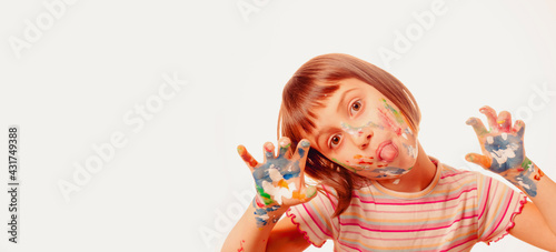 Funny portrait of huppy beautiful young child girl with colorful painted face and hands. Free copy space for design or text.