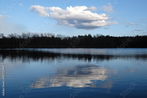 Beautiful scenery with reflection of cloud in lake in evening light