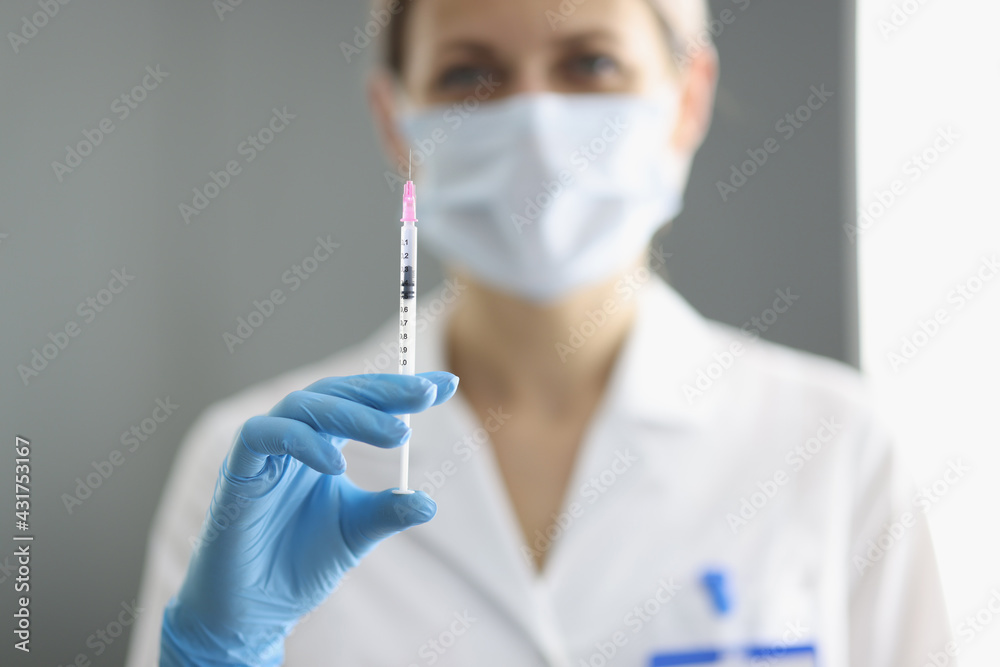 Portrait of doctor in whose hand medical syringe with needle Portrait of doctor in whose hand medical syringe with needle