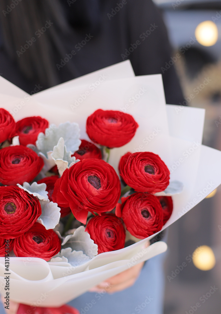 Fresh beautiful flower. Woman holding a red flower bouquet of ranunculus and greenery. Fresh beautiful flower. Woman holding a red flower bouquet of ranunculus and greenery.