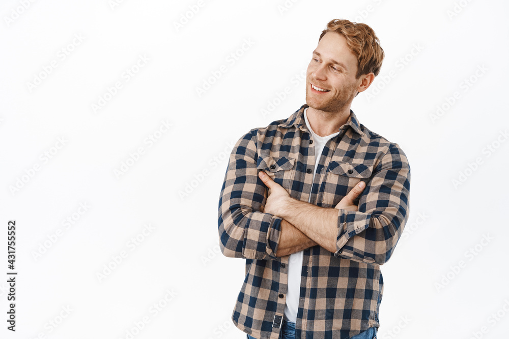 Handsome adult redhead man looking pleased aside, reading promotional text logo, staring left at advertisement with confident and satisfied face, cross arms on chest, white background Handsome adult redhead man looking pleased aside, reading promotional text logo, staring left at advertisement with confident and satisfied face, cross arms on chest, white background