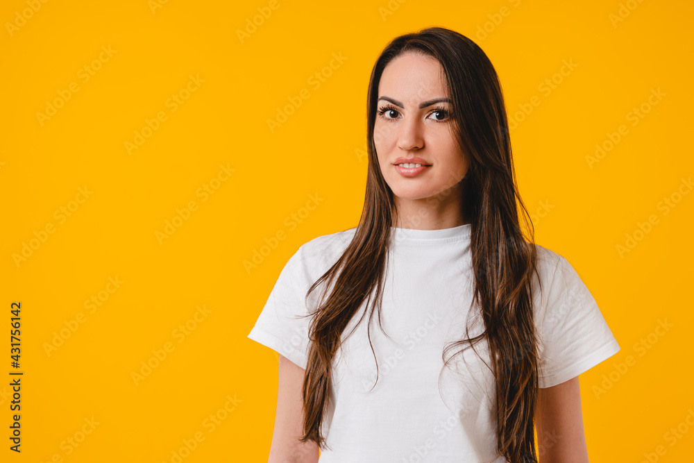 Image of a young beautiful caucasian woman in white T-shirt isolated over yellow background. White nice-looking girl advertisement, cutout Image of a young beautiful caucasian woman in white T-shirt isolated over yellow background. White nice-looking girl advertisement, cutout