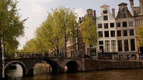 Amsterdam, Netherlands, April 2011: A cityscape of a charming side of the city with a three arch bridge.