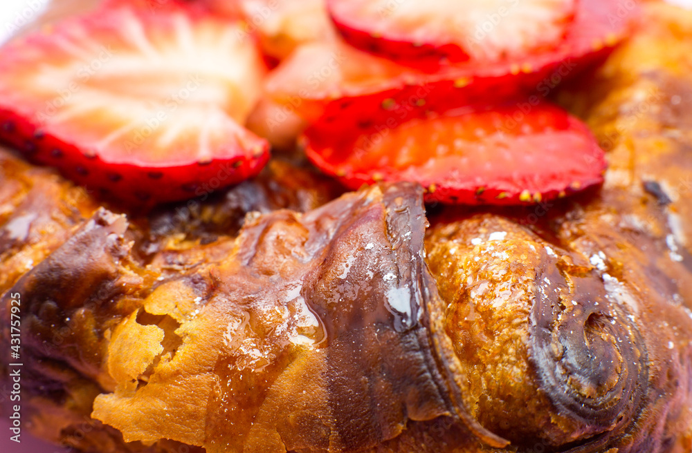 Puff pastry bun or roll. Cake with fresh strawberries. Delicious sweets temptation and desserts on a pink background. Minimalism, original and creative image. Beautiful food wallpaper. Puff pastry bun or roll. Cake with fresh strawberries. Delicious sweets temptation and desserts on a pink background. Minimalism, original and creative image. Beautiful food wallpaper.