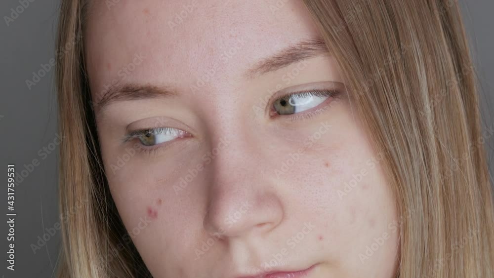 Beautiful young girl without makeup with a natural appearance posing in front of the camera in the studio Beautiful young girl without makeup with a natural appearance posing in front of the camera in the studio