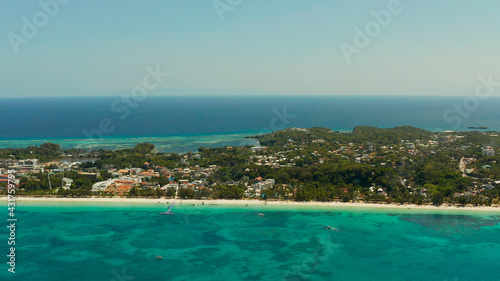 Tropical lagoon with turquoise water and white sand beach from above. Boracay, Philippines. White beach with tourists and hotels. Summer and travel vacation concept.