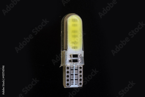 Car light bulb emitting diode, accessories and components for electronics vehicles. copy space. Black background close-up. 12V T10 photo